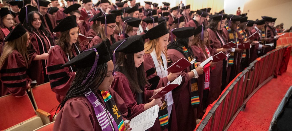 group of graduates reading declaration of professional commitment