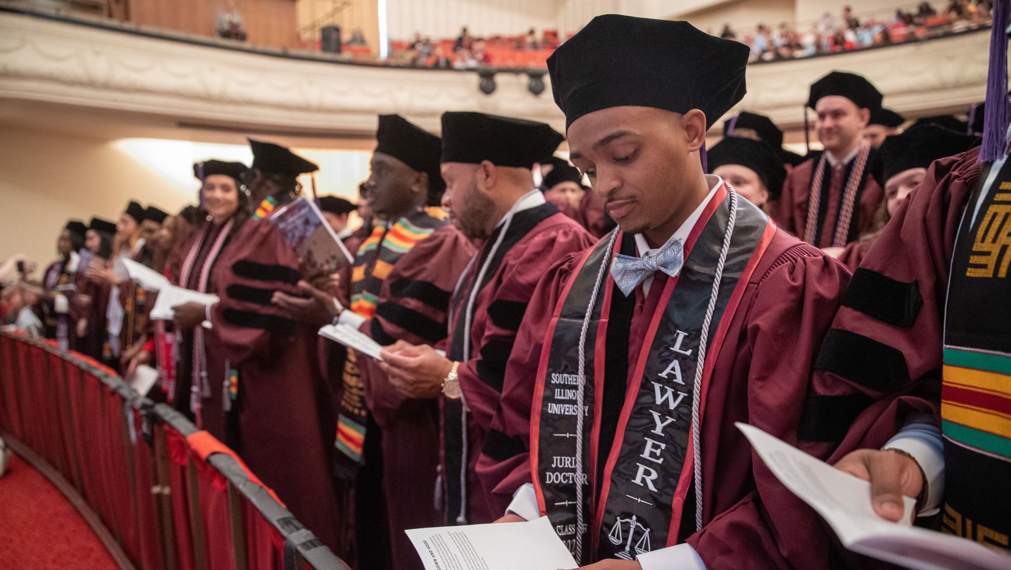 SIU law student accepts award from professor during commencement ceremonies