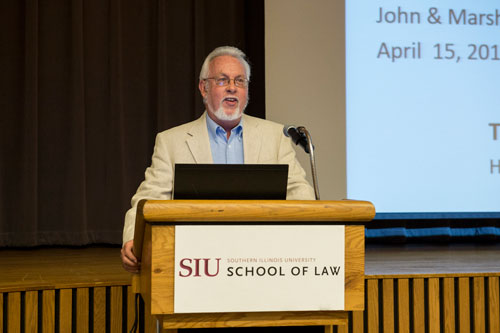 W. Eugene Basanta speaking at a podium