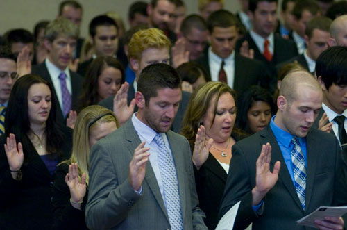 Entering students reciting the pledge at an induction ceremony